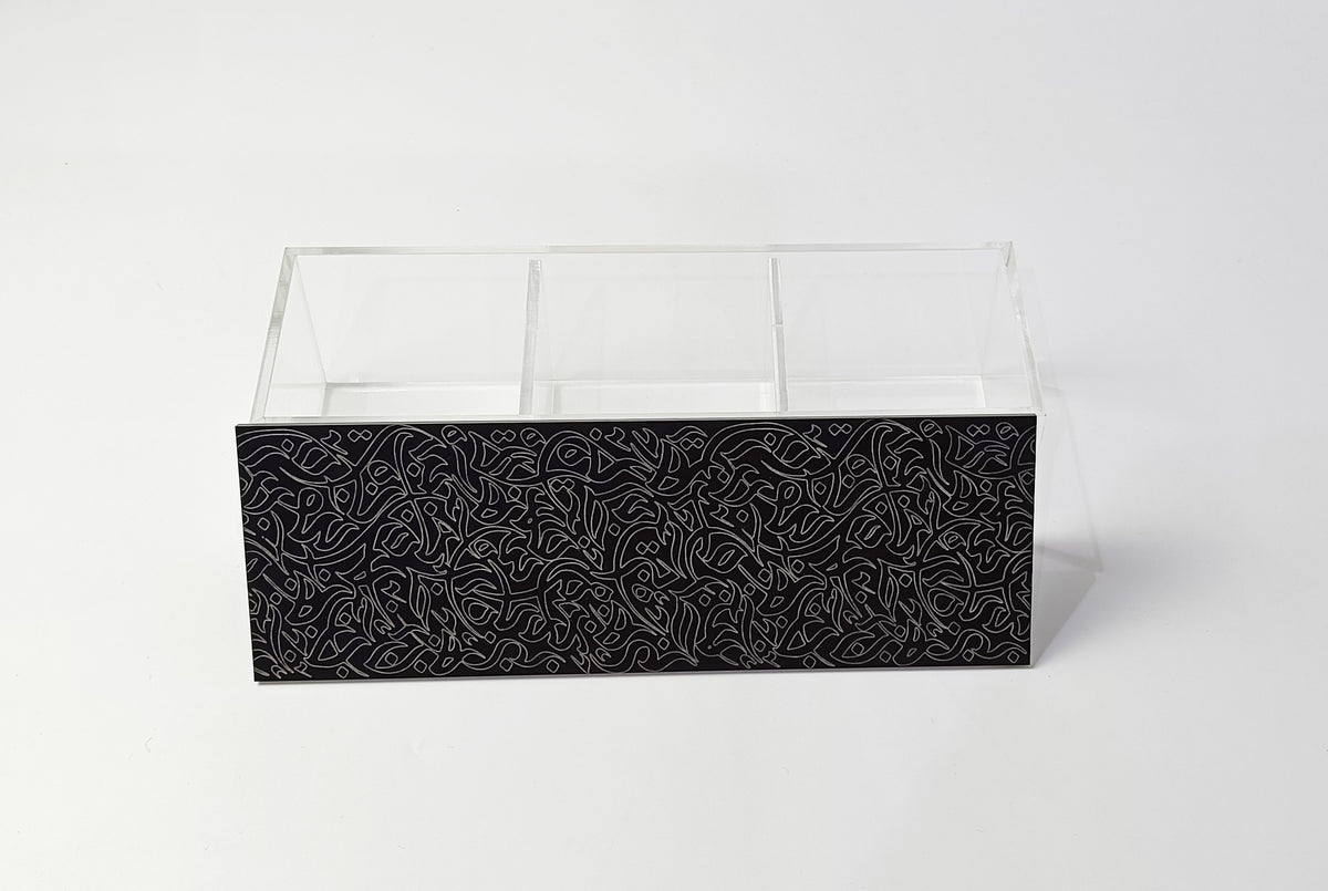 Divided clear acrylic box with a black engraved calligraphy front panel