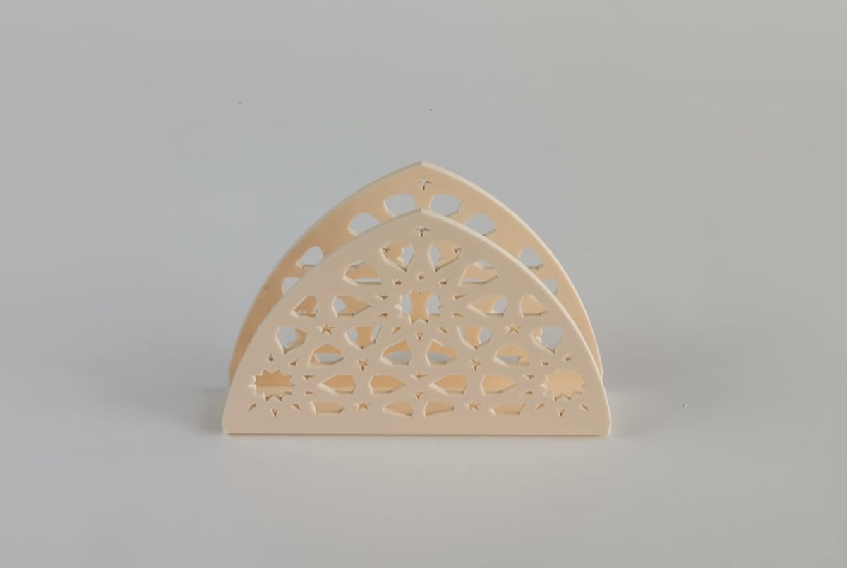 Cream arch-shaped napkin holder pierced with an arabesque lattice