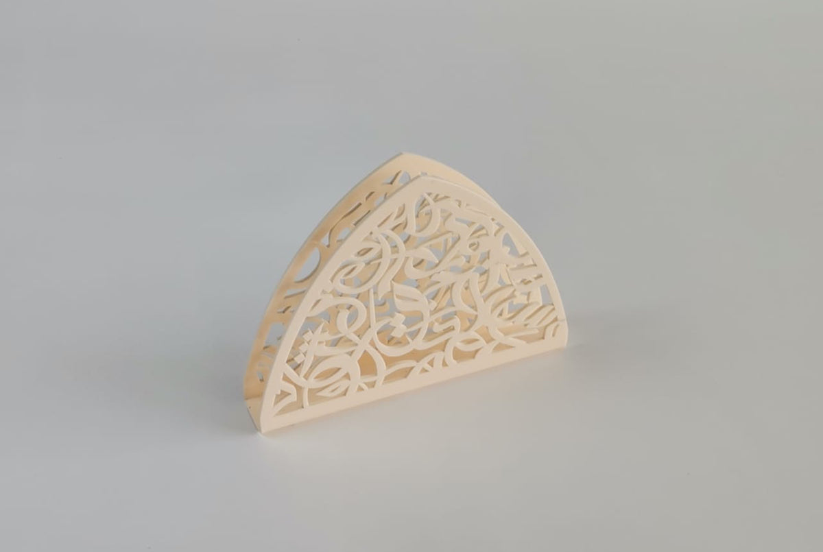Cream arabesque napkin holder seen from a low angle