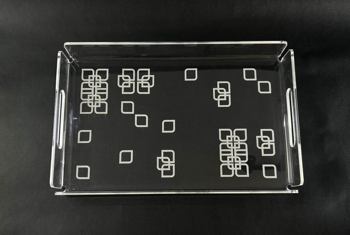 Clear acrylic tray scattered with white square motifs, seen from above