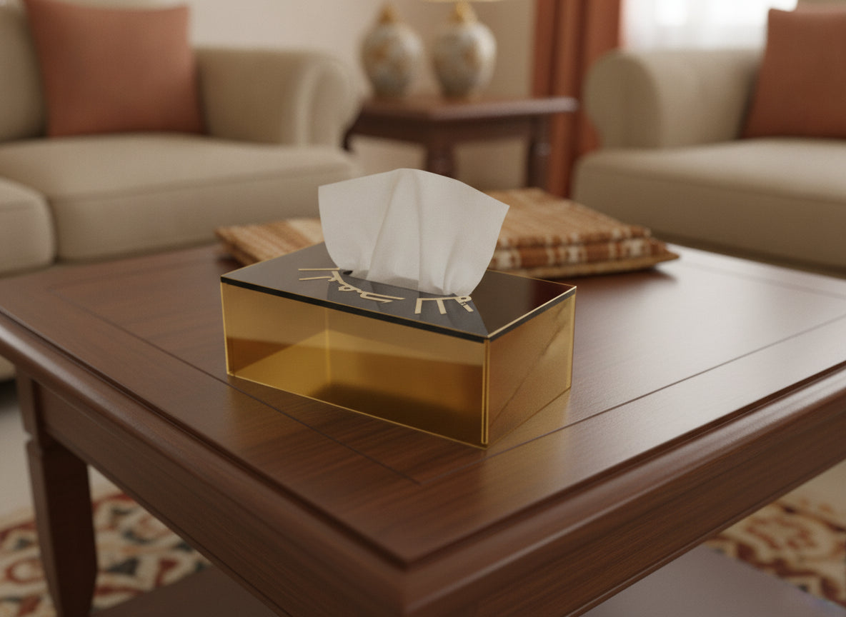 «الحمد لله» in Kufi engraved on an acrylic tissue box, photographed on a table