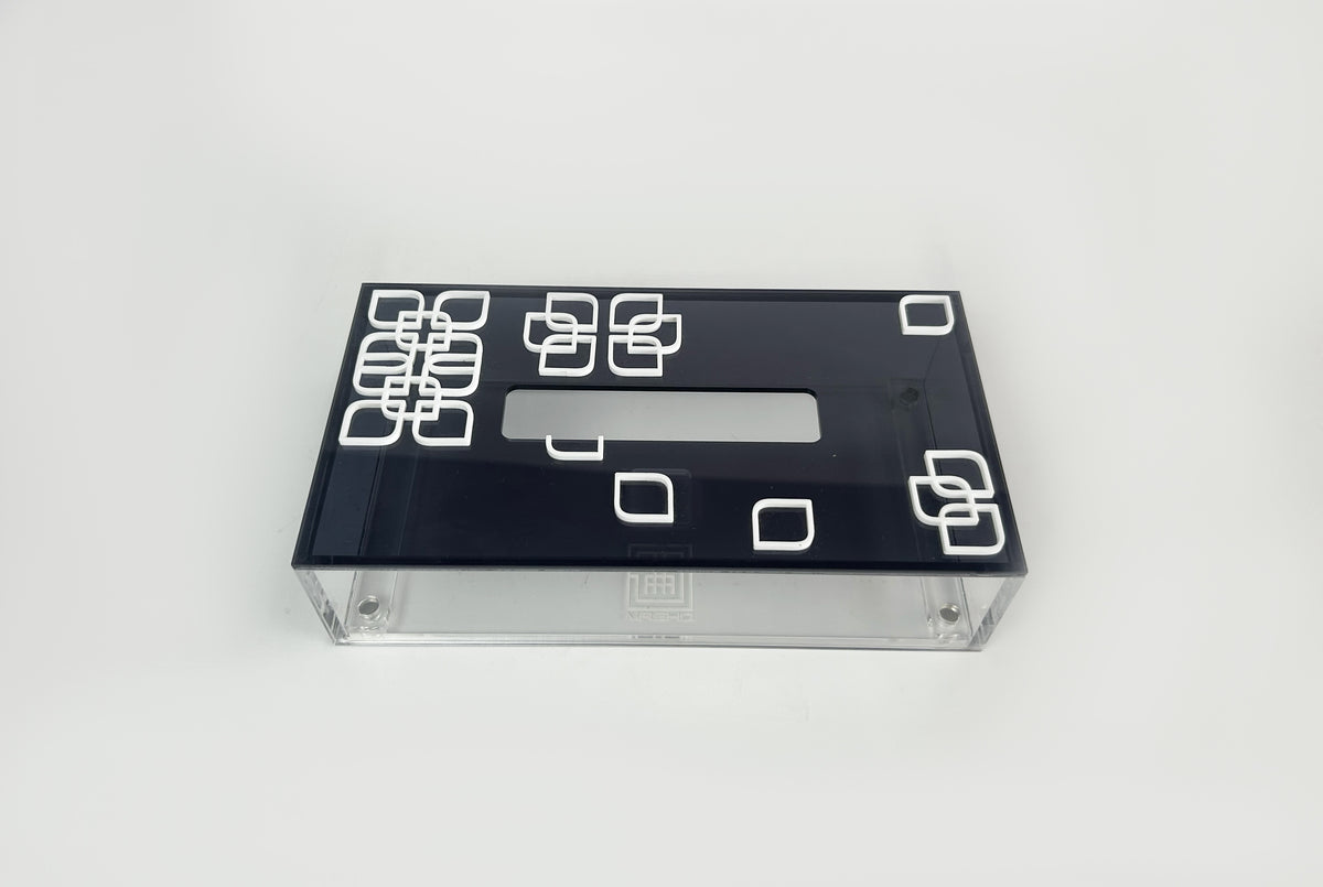 Black tissue box lid with white square motifs on a clear acrylic base