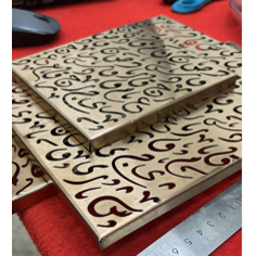 Gold Diwani-patterned box lid resting on the box, with a ruler alongside for scale