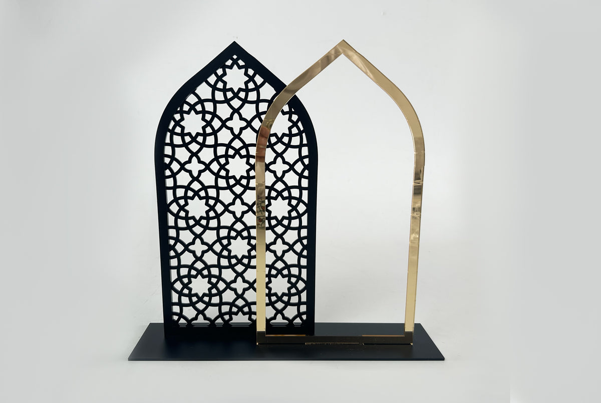 Black pierced mashrabiya arch on a black base with a gold arch alongside