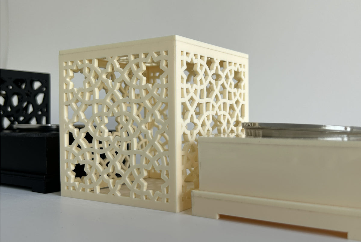 Cream and black pierced censers grouped with their bases