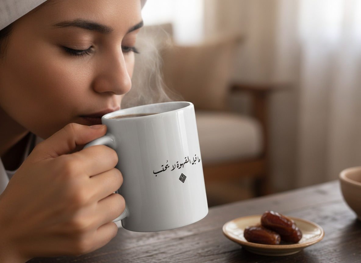 «ما قبل القهوة لا يُحتسب» calligraphy mug in hand, mid-sip